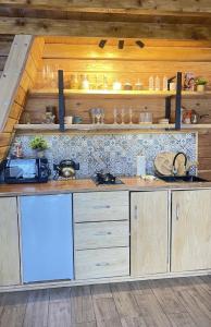 a kitchen with wooden cabinets and a counter top at Mountain villa in Skhidnitsa