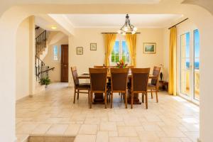 a dining room with a table and chairs at Ioannas House in Nisaki