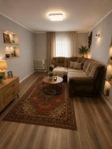 a living room with a couch and a coffee table at Садиба у Оксани in Verkhneye Sinevidnoye