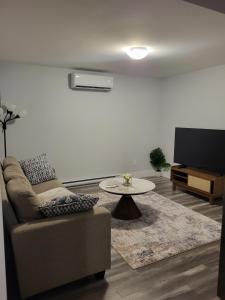 a living room with a couch and a table at Peace Home in Dieppe