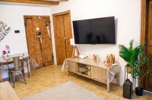 a living room with a flat screen tv on a wall at Charmant appartement climatisé en plein coeur du village et proche des plages avec wifi in Cervione