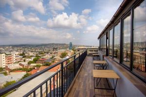 a balcony with benches and a view of a city at Hotel Beli in Tbilisi City