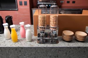 a counter top with containers of cereals and a box at Blues Suites Laureles in Medellín