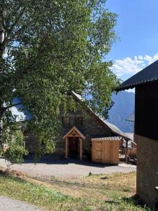 a log cabin with a gambrel roof at Les Racines Chalet in Villard-Reculas