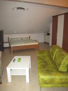 a living room with a couch and a table at Ferienwohnungen Tollhof - Near Bolzano and castles, with a guest card for families and couples, offering panoramic views in Cornaiano