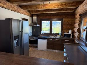 a kitchen with a refrigerator and a sink at Liptovsky Zrub in Gôtovany