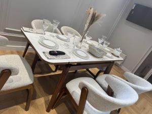 a white table with chairs and a vase on it at NRG BI Sado in Katartal +4 photos