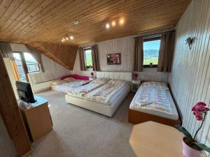 a room with two beds and a tv in it at Liptovsky Zrub in Gôtovany