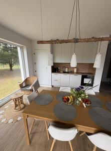 a kitchen and dining room with a table and chairs at Sosnowy Zakątek in Radęcin +16 photos