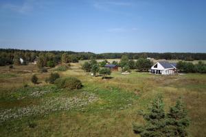 an aerial view of a field with a house at Sosnowy Zakątek in Radęcin