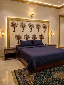a bedroom with a bed with a blue comforter at Tripo bay inn in Mahabalipuram