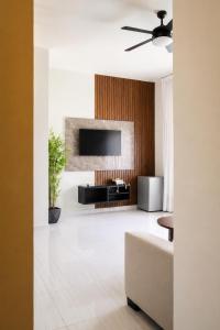 a living room with a television and a couch at Skylight Suites Hotel in San Felipe de Puerto Plata