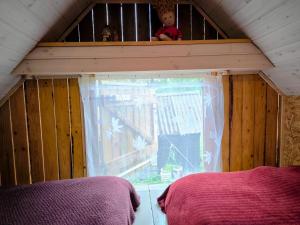 a bedroom with a window in a tiny house at Sauna Suite 2 in Valga