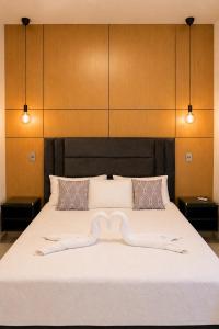 a bedroom with a large bed with a bow on it at Skylight Suites Hotel in San Felipe de Puerto Plata +60 photos