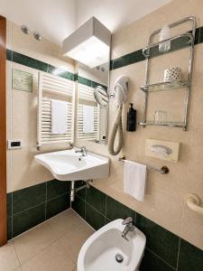 a bathroom with a sink and a toilet and a mirror at Hotel Italia in Ravenna +29 photos