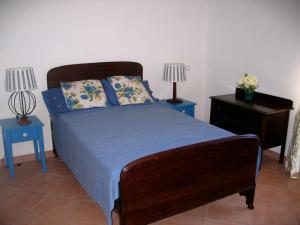 a bedroom with a bed with two tables and two lamps at Villa with River Access in Cocciglia