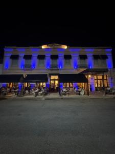 a building with blue lights on it at night at Le Flâneur Boutique Hotel in Pergamino