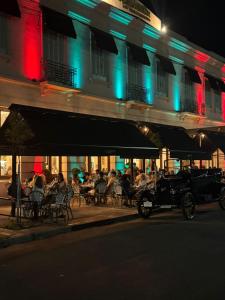 an old car parked in front of a restaurant at night at Le Flâneur Boutique Hotel in Pergamino +5 photos