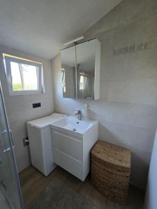 a white bathroom with a sink and a mirror at Studios Ilic in Seline