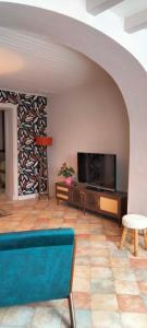 a living room with a large flat screen tv at Entre vigne et Loire in La Coindassière