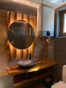 a bathroom with a sink and a mirror at Vila Vlasinski mir in Surdulica