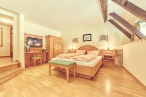 a bedroom with a bed and a desk and a tv at Landgasthof zur Sonne in Wehr