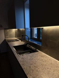 a kitchen counter with a sink and a window at Villa Panόrama in Riglia +33 photos