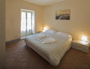 a bedroom with a bed with two towels on it at Terrediliguria - Lerici in Lerici