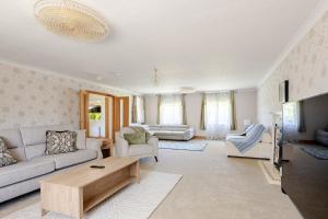 a living room with a couch and a table at The Limes Bungalow in Market Rasen