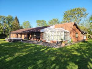a large brick house with a large backyard at The Limes Bungalow in Market Rasen