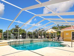 a swimming pool with a white pergola over it at 3BR Home Trailside Pool & Jacuzzi, Minutes from Inverness, Ocala & Crystal River in Inverness