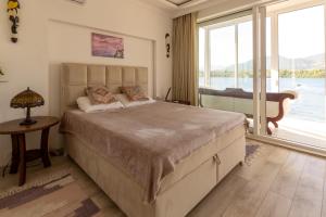 a bedroom with a large bed and a large window at Aquamarine House in Tivat +26 photos
