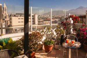 a balcony with plants and a view of a city at Maison verte - Guest House in Arequipa +50 photos