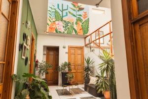 a hallway with potted plants in a building at Maison verte - Guest House in Arequipa