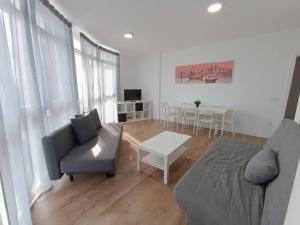 a living room with a couch and a table at Apartamentos Illa Pancha in Ribadeo
