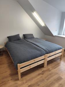 a bedroom with a bed with a blue blanket at Centro-loftas in Telšiai