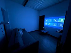 a dark room with a couch in a blue room at Villa campestre Las Palmas in Calima
