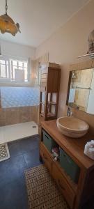a bathroom with a sink and a counter with a mirror at Le cocon in Carpentras