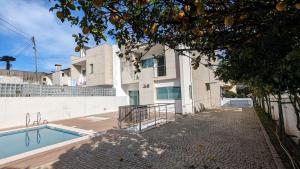 a house with a swimming pool next to a building at Mansion with Swimming Pool, Pool Table & GrillArea in Braga