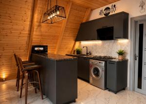 a kitchen with a stove and a washing machine at Area36 Family Chalet in Gabala