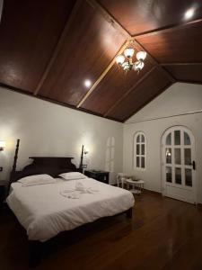 a bedroom with a large bed with a wooden ceiling at Vanvaas the forest note in Godarpura