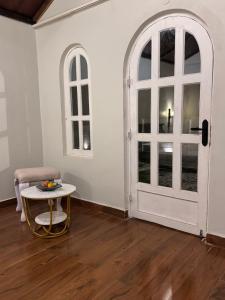 a room with a white door and a table at Vanvaas the forest note in Godarpura +7 photos