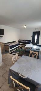 a room with several mattresses and tables and chairs at Apartament Przylesie 2 in Stężyca +1 photo