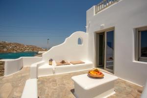a white staircase with a bowl of fruit on it at Stilvi Mykonos in Ornos