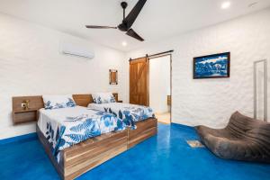 a bedroom with two beds and a ceiling fan at Villa Peuchere in Santa Cruz