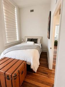a bedroom with a bed and a suitcase at Modern Main Street Charm in Georgetown