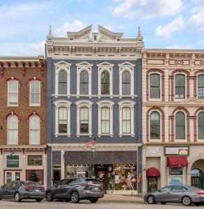 a blue building on a street with cars parked in front at Modern Main Street Charm in Georgetown
