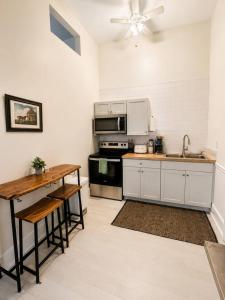 a kitchen with a table and a stove top oven at Main Street Stay in Georgetown