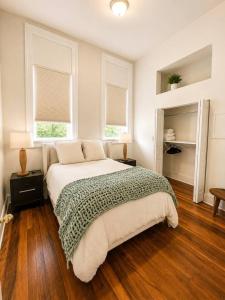 a bedroom with a large bed and two windows at Main Street Stay in Georgetown