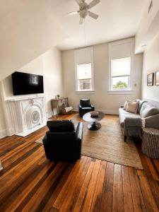a living room with a couch and a fireplace at Main Street Stay in Georgetown